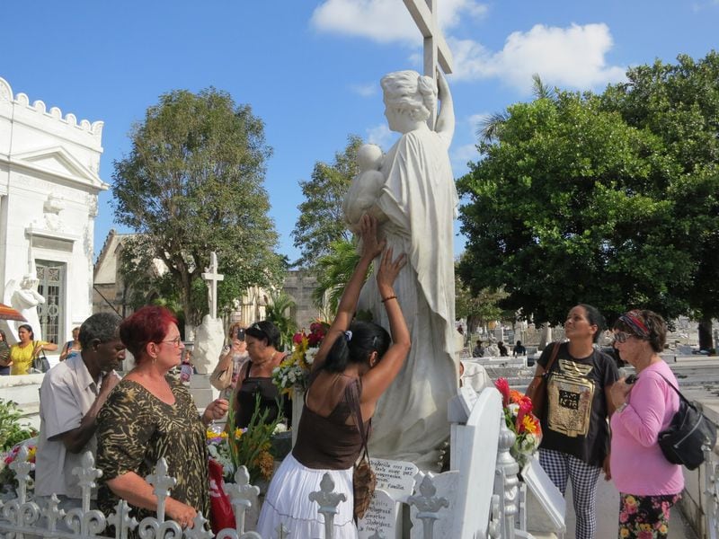 Cubans pray at the grave of La Milagrosa in Cementerio de Colón. CONTRIBUTED BY WESLEY K.H. TEO
