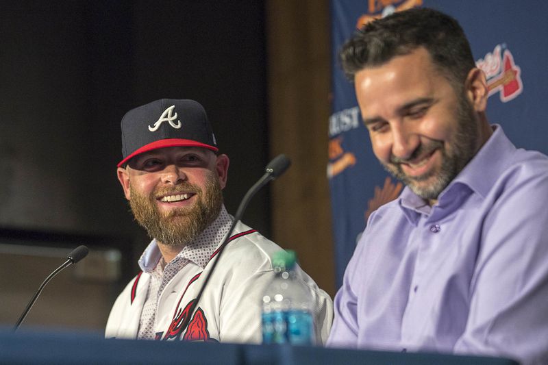 Braves GM Alex Anthopoulos shares the stage with an oldie but a goodie he brought back to the Braves, catcher Brian McCann. (ALYSSA POINTER/ALYSSA.POINTER@AJC.COM)