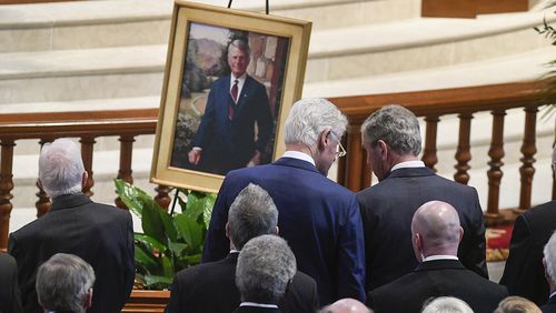 Former Presidents Bill Clinton talks to George W. Bush, right, as they and Jimmy Carter, left, attend the funeral for former Governor and U.S. Senator Zell Miller held at Peachtree Road United Methodist Church, Tuesday March 27, 2018, in Atlanta. Miller, a conservative democrat, died at 86 from complications from Parkinson's disease four days ago on March 23 at his home in Young Harris, Ga. (John Amis)