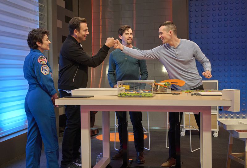 LEGO MASTERS: L-R: Guest star Jessica Meir (astronaut), Host Will Arnett and contestants Brendon and Greg in the “Ready to Launch” season three premiere episode of LEGO MASTERS airing Wednesday, Sept. 21 (9:00-10:00 PM ET/PT) on FOX.. ©2022 FOX MEDIA LLC. CR: Tom Griscom/FOX