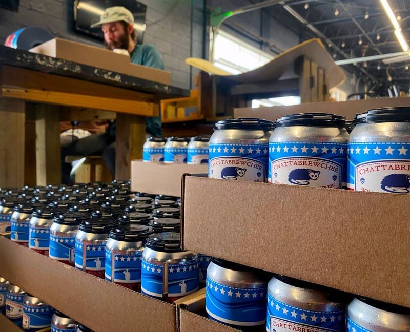 Workers at Chattabrewchee Southern Brewhouse in Columbus, Georgia label nearly 1,000 cans of Chattabrewchee’s Lazy River Lager. (Photo Courtesy of Mike Haskey)