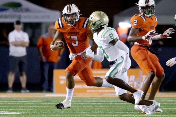 August 20, 2021 - Kennesaw, Ga: North Cobb quarterback Malachi Singleton (3) runs for a first down against Buford defensive back Ryland Gandy (8) during the first half at North Cobb high school Friday, August 20, 2021 in Kennesaw, Ga.. JASON GETZ FOR THE ATLANTA JOURNAL-CONSTITUTION