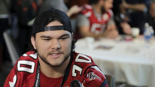 The Falcons Jake Matthews relaxes and enjoys his Super Bowl press gathering Wednesday. (Tim Warner/Getty Images)