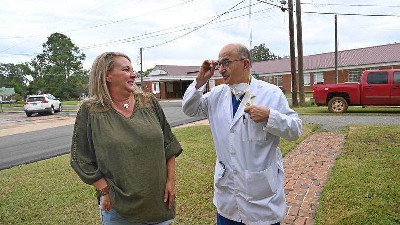 Laura Wiggins greets Dr. Abdollatif Saleh Ghiathi outside his office across from Southwest Georgia Regional Medical Center (background) in Cuthbert. Wiggins had a heart attack and was treated by Dr. Ghiathi at the hospital, which is closing in October. (Hyosub Shin / Hyosub.Shin@ajc.com)