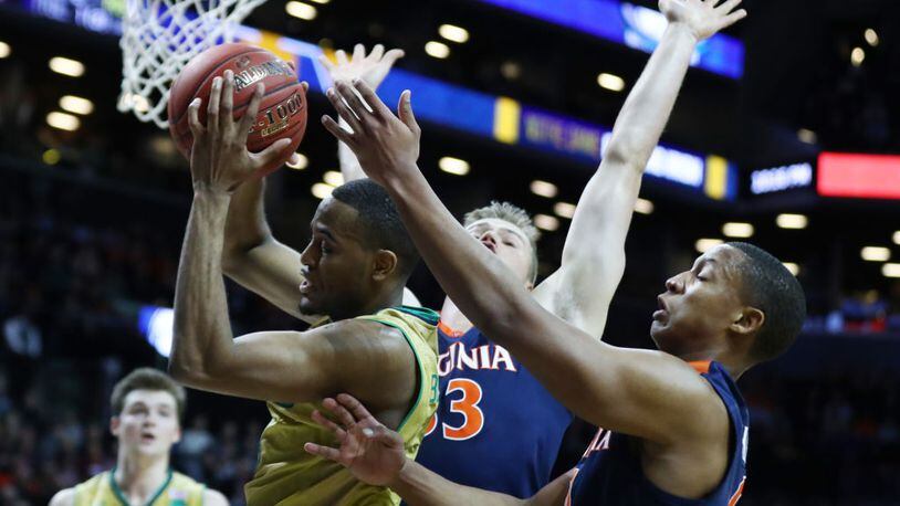 NEW YORK, NY - MARCH 09: V.J. Beachem #3 of the Notre Dame Fighting Irish battles for the ball with Devon Hall #0 of the Virginia Cavaliers during the Quarterfinals of the ACC Basketball Tournament at the Barclays Center on March 9, 2017 in New York City. (Photo by Al Bello/Getty Images)