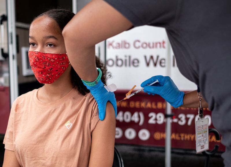 Kadence Booker, 13, gets a COVID-19 vaccination at a mobile clinic at Decatur High School on Tuesday. (Ben Gray for The Atlanta Journal-Constitution)
