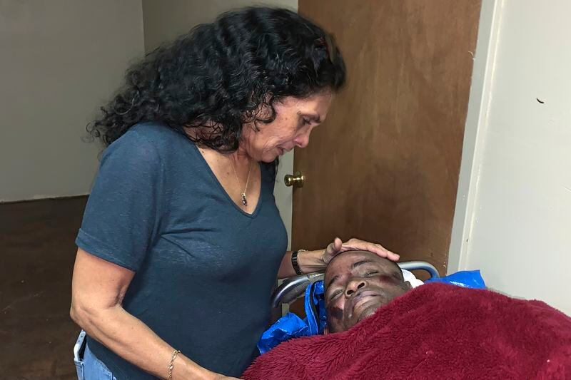 FILE - In this photo provided by Alana Wilson, Mona Hardin looks over the body of her son, Ronald Greene in Rayville, La., on May 13, 2019. Hardin has been waiting five long years for any resolution to the federal investigation into her son’s deadly arrest by Louisiana State Police troopers, an anguish only compounded by the fact that nearly every other major civil rights case during that time has passed her by. (Alana Wilson via AP, File)