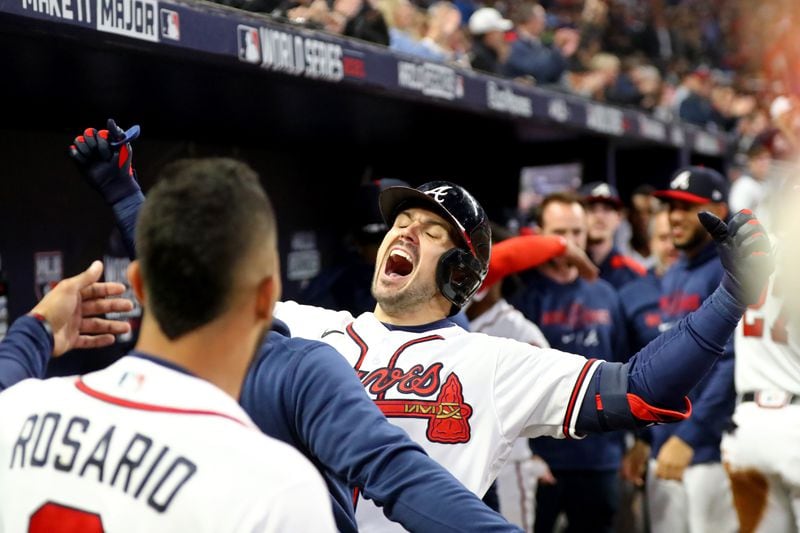 Braves center fielder Adam Duvall celebrates his grand slam home run to put the Braves up 4-0 with teammates in the dugout during the first inning against the Houston Astros in game 5 of the World Series at Truist Park, Sunday, October 31, 2021, in Atlanta.Curtis Compton / curtis.compton@ajc.com