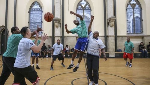 Players from the Outley House go up against Our Brothers’ Place during a game at the Church of the Advocate in North Philly. Men from both shelters participate in a basketball league run by Hoops for Hope. Steven M. Falk/The Philadelphia Inquirer/TNS