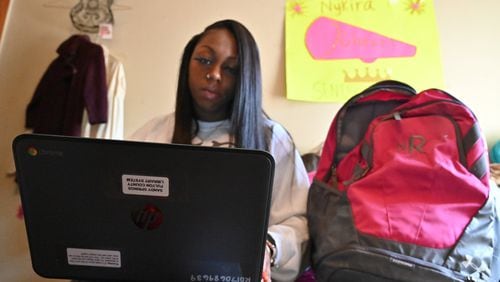 Nykira Ross checks emails using a laptop that she borrowed from Fulton County library after leaving Albany State University in the wake of the COVID-19 outbreak. Hyosub Shin / Hyosub.Shin@ajc.com