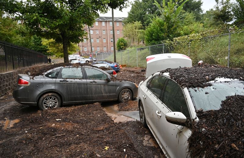 Damaged cars are shown stuck in the mud after storms dropped nearly four inches of rain near Clark Atlanta University campus on Friday, September 15, 2023, in Atlanta. (Hyosub Shin / Hyosub.Shin@ajc.com)
