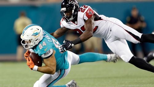 Miami Dolphins tight end Jordan Cameron (84) is brought down by Atlanta Falcons strong safety Keanu Neal (22) after a reception during the first half of an NFL preseason football game in Orlando, Fla., Thursday, Aug. 25, 2016.(AP Photo/Willie J. Allen Jr.)