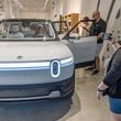 Sabrina Eijan takes a photograph of the new Rivian R2 prototype that will eventually be made in Georgia at the Ponce City Market in Atlanta on April 27, 2024.  (Steve Schaefer / AJC)