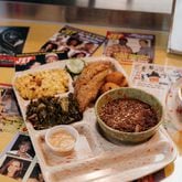 This catfish platter at Good Hot Fish includes Sea Island red peas, stewed greens, macaroni and cheese, refrigerator pickles, hush puppies and tartar sauce. Courtesy of Good Hot Fish
