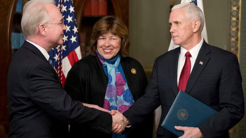 Vice President Mike Pence shakes hands with Health and Human Services Secretary Tom Price, accompanied by his wife Betty, after a swearing-in ceremony last February. AP/Andrew Harnik