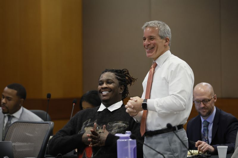 Defense attorney Brian Steel and his client, rapper Young Thug, react moments before his trial enters the second week at Fulton County Courthouse on Monday, Dec. 4, 2023.
Miguel Martinez /miguel.martinezjimenez@ajc.com