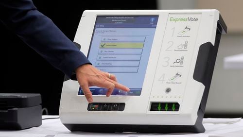 A voting machine displayed this summer at a meeting of a commission named by Secretary of State Brian Kemp. BOB ANDRES /BANDRES@AJC.COM