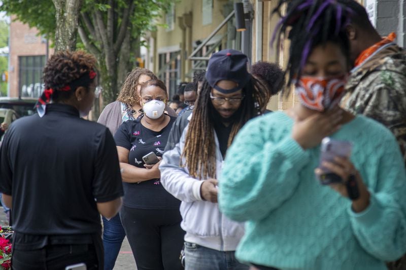 04/30/2020 - Atlanta, Georgia - Some individuals wear masks as they wait in line for their lunch orders outside of the Slutty Vegan ATL restaurant, located at 1542 Ralph David Abernathy Boulevard SW, in Atlanta’s Westview community, Thursday, April 30, 2020. (ALYSSA POINTER / ALYSSA.POINTER@AJC.COM)
