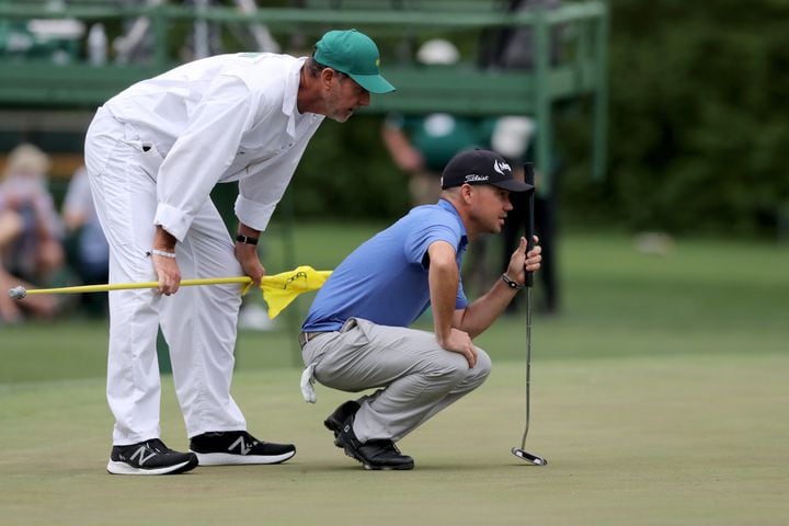 April 9, 2021, Augusta: Brian Harman and his caddie Scott Tway lineup a putt on the fifteenth green during the second round of the Masters at Augusta National Golf Club on Friday, April 9, 2021, in Augusta. Curtis Compton/ccompton@ajc.com