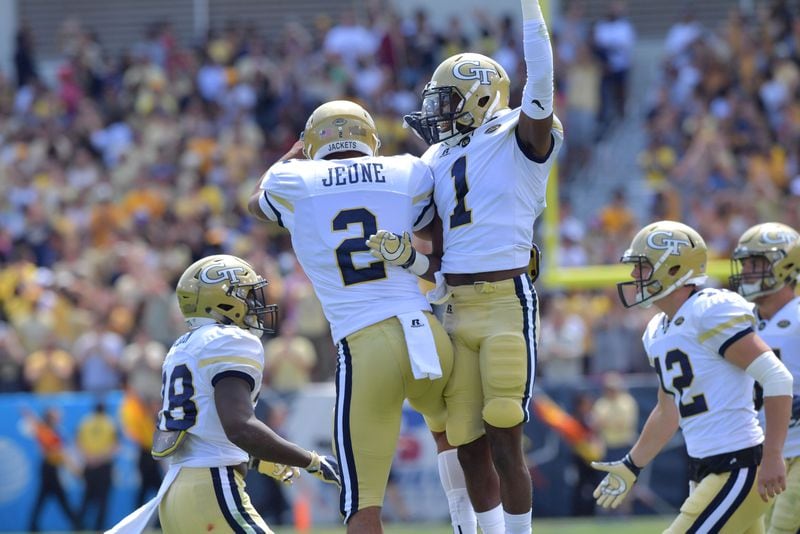 Ricky Jeune (2) and Qua Searcy (1) celebrate after Jeune's touchdown in the first half of the Jackets' 37-10 victory over Jacksonville State Sept. 9. Hyosub Shin/hshin@ajc.com