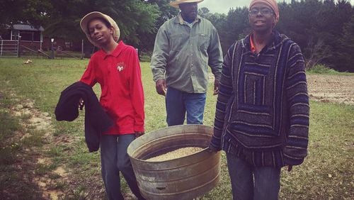 Salu Binahtabor (from left), 13, author of “Be Bugged: Beneficial Insects for Farmers and Gardeners,” Kevin Springs, a land owner in the Southeast, and Felicia Bell of SAAFON represent a new generation of black farmers. CONTRIBUTED BY SAAFON