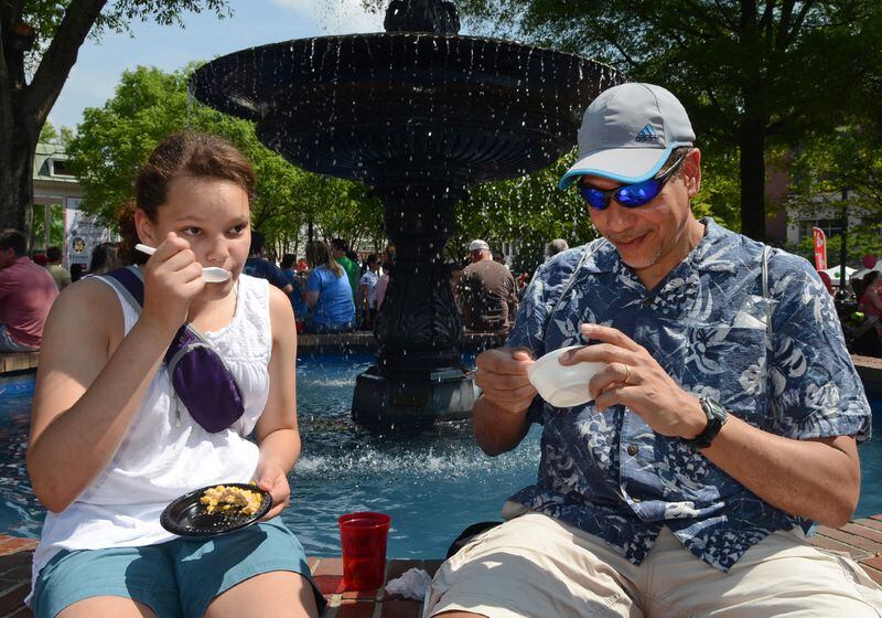 April 27, 2014: Daughter and father Melissa and Ken Jones enjoy corn chowder and lobster and sauce by the fountain during the 21st Annual Taste of Marietta Celebration.