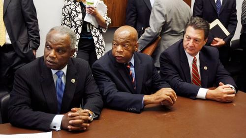 Rep. David Scott, D-Ga., left, Rep. John Lewis, D-Ga., and Rep. Lynn Westmoreland, R-Ga., take their seats as the Georgia Congressional delegation meets over Georgia's use of Lake Lanier's water on Capitol Hill in Washington, Tuesday, July 21, 2009. (AP Photo/Gerald Herbert) Rep. David Scott, D-Ga., left, Rep. John Lewis, D-Ga., center, in 2009. (AP Photo/Gerald Herbert)