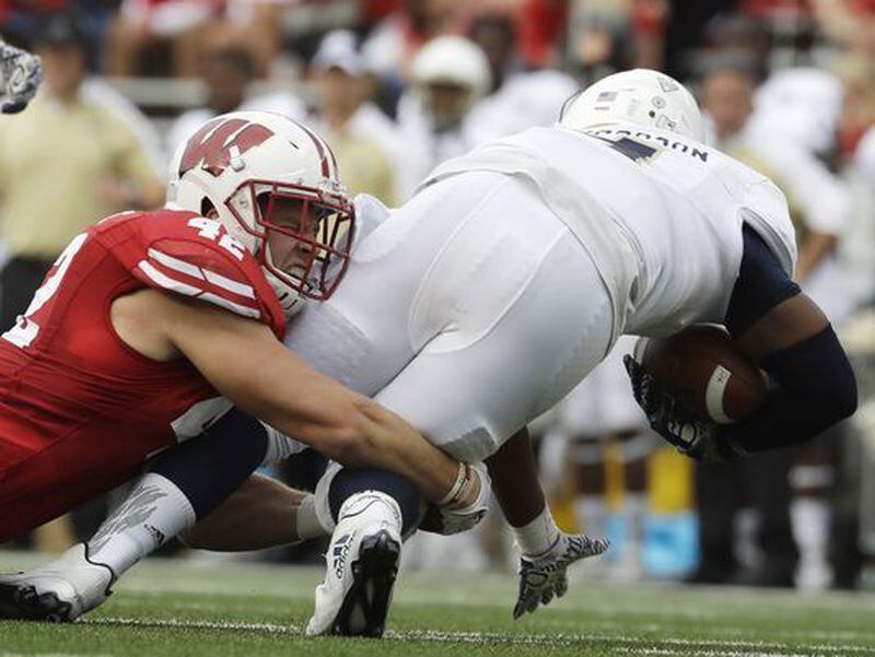  Wisconsin's T.J. Watt sacks Akron quarterback Thomas Woodson during the second half of an NCAA college football game Saturday, Sept. 10, 2016, in Madison, Wis. (AP Photo/Morry Gash)(Photo: The Associated Press)