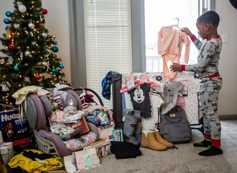 Bianca Johnson and her 7-year-old son Brayden are overwhelmed with gratitude for the gifts from their Nextdoor community.  (Jenni Girtman for The Atlanta Journal-Constitution)