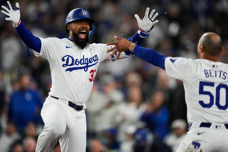 Los Angeles Dodgers' Teoscar Hernández celebrates with Mookie Betts (50) after hitting a home run during the third inning of a baseball game against the Miami Marlins in Los Angeles, Monday, May 6, 2024. (AP Photo/Ashley Landis)