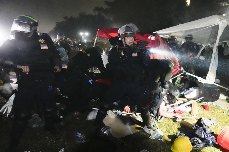Police advance on pro-Palestinian demonstrators in an encampment on the UCLA campus Thursday, May 2, 2024, in Los Angeles. (AP Photo/Jae C. Hong)