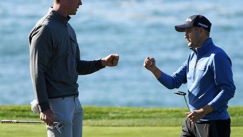 NFL player Matt Ryan and Russell Knox of Scotland bump fists on the eighth green during the third round of the AT&T Pebble Beach Pro-Am at Pebble Beach Golf Links on February 09, 2019 in Pebble Beach, California. (Photo by Harry How/Getty Images)
