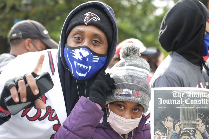 Braves fan Brian Long, a 33-year-old filmmaker, and his daughter attended the Braves' World Series celebration parade in Atlanta on Nov. 5, 2021. (Photo by Anfernee Patterson/AJC)