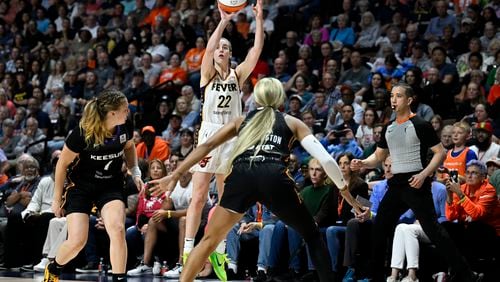 Indiana Fever guard Caitlin Clark (22) puts up a 3-point shot to score against the Connecticut Sun during the fourth quarter of a WNBA basketball game, Tuesday, May 14, 2024, in Uncasville, Conn. (AP Photo/Jessica Hill)