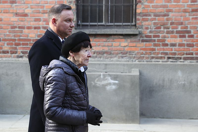 Poland's President Andrzej Duda and Zofia Optulowicz, the daughter of Polish World War II resistance leader Witold Pilecki, attend a wreath-laying ceremony Monday at the Auschwitz Nazi death camp in Oswiecim, Poland.