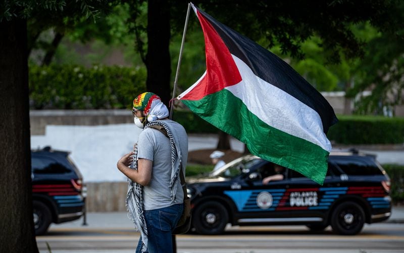 A demonstrator brought a Palestinian flag to a gathering in downtown Atlanta. 