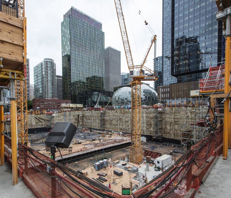 This angle looks across the foundation of another Amazon building being built near Amazon’s Doppler building at left, and its Spheres and Day 1 building at right, in downtown Seattle, Wash. On Thursday, Amazon said it wants to build a second North American headquarters to rival its Seattle base of operations. (Steve Ringman/Seattle Times/TNS)