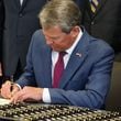 Gov. Brian Kemp signs House 1105 also known as Georgia Criminal Alien Track and Report Act of 2024 at Georgia Public Training Center in Forsyth, Ga. on Wednesday, May 1, 2024. (Natrice Miller/ AJC)