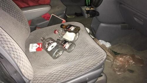 Dunwoody police said they found these bottle of alcohol inside a van that allegedly drove through a church's Christmas tree lot during service.