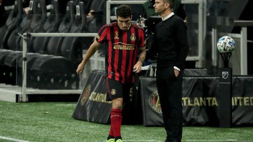 Atlanta United interim manager Stephen Glass greets midfielder Eric Remedi, left, as he returns to the bench in the second half against Miami at Mercedes-Benz Stadium Saturday, September 19, 2020 in Atlanta. Atlanta United lost to Miami 2-1. JASON GETZ FOR THE ATLANTA JOURNAL-CONSTITUTION