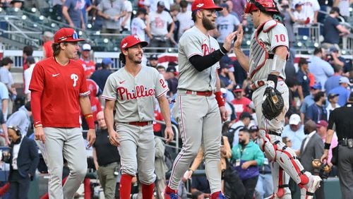 The Phillies celebrate winning game one of the baseball playoff series between the Braves and the Phillies at Truist Park in Atlanta on Tuesday, October 11, 2022. (Hyosub Shin / Hyosub.Shin@ajc.com)