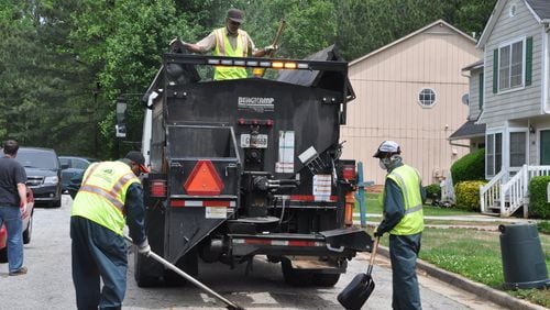 DeKalb County workers fill a pothole.
