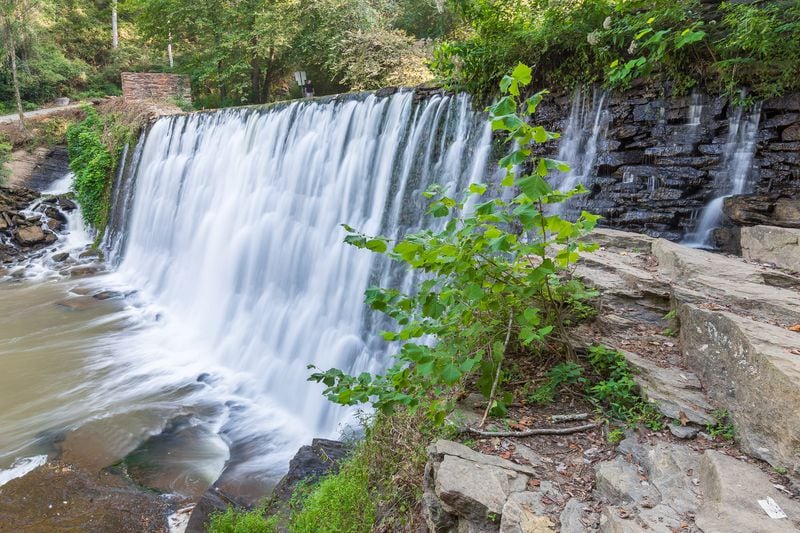 Vickery Creek Falls rushes over a historic dam into a serene pool of water in the Chattahoochee National Recreation Area.