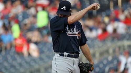Starting pitcher R.A. Dickey of the Braves reacts after giving up back-to-back home runs. (Photo by Rob Carr/Getty Images)