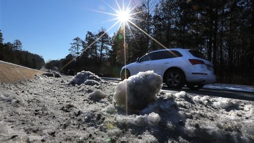 January 8, 2017, Woodstock: A motorist passes by chunks of ice on a still icy patch of Town Lake Parkway on Sunday, Jan. 8, 2017, in Woodstock.    Curtis Compton/ccompton@ajc.com