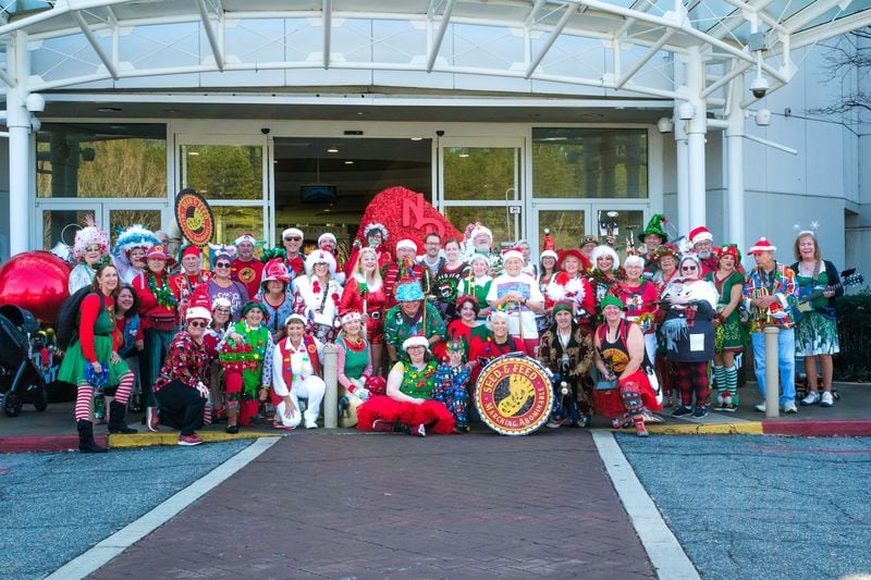 The Seed & Feed Marching Abominable Band, seen here in a Christmas-themed group shot, celebrates 50 years of music and mischief-making. Photo: Juliette Mansour/Casa Dresden