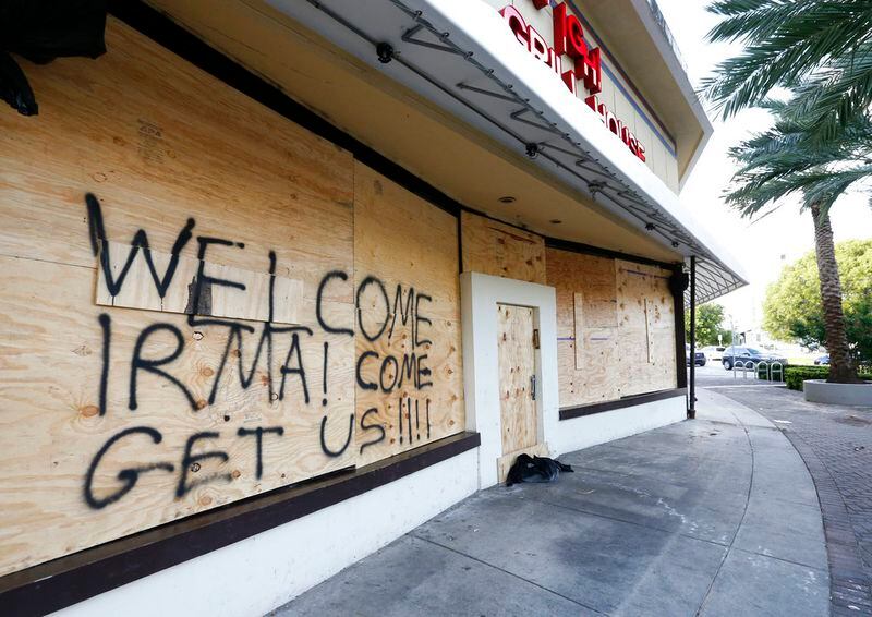 A message to Hurricane Irma is written on the facade of a boarded restaurant, Friday, Sept. 8, 2017 in Miami Beach, Fla. The first hurricane warnings were issued for parts of southern Florida as the state braced for what could be a catastrophic hit over the weekend. (AP Photo/Wilfredo Lee)
