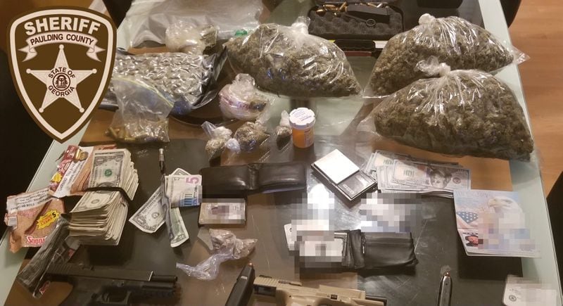 A total four pounds of marijuana, two ounces of heroin, three handguns and a substantial amount of cash were seized after a traffic stop and a raid on a south Paulding County home on Oct. 21, according to authorities. 