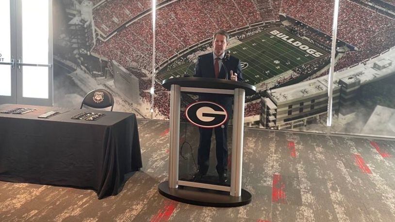 Georgia Gov. Brian Kemp speaks Thursday to a small gathering in the Georgia Bulldogs' recruiting lounge at Sanford Stadium before signing into law House Bill 617, which will give college athletes the right to make money off their name, image or likeness. (Photo by Greg Bluestein/AJC)