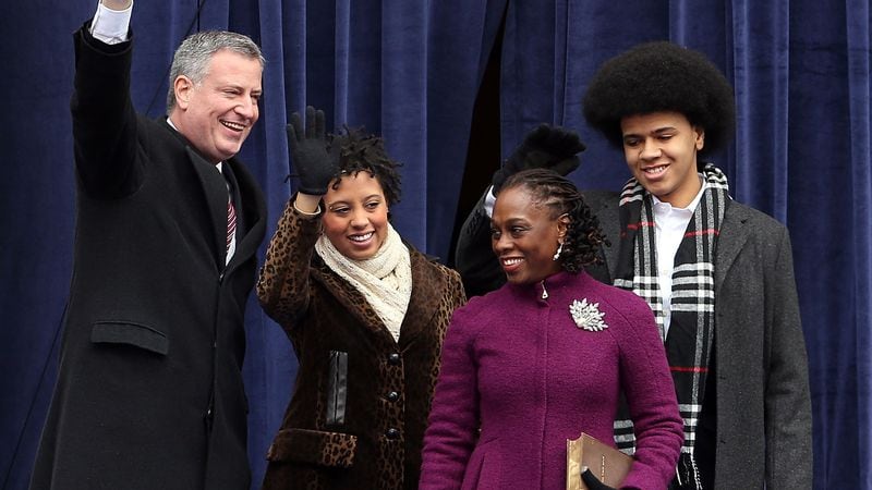 New York Mayor Bill de Blasio and Chirlane McCray (front), with their children Chiara and Dante, wave at City Hall following de Blasio's inauguration in 2014. (Photo by Spencer Platt/Getty Images)